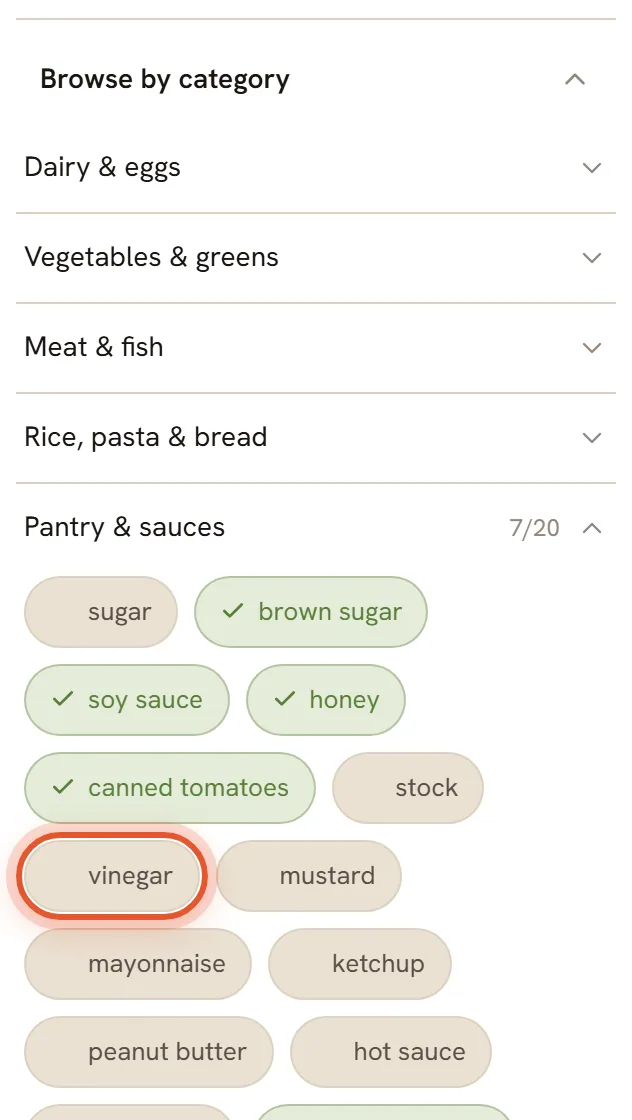 Browse by category with the Pantry and sauces group open. Chips you already have are green with a check mark, and the vinegar chip is ringed.